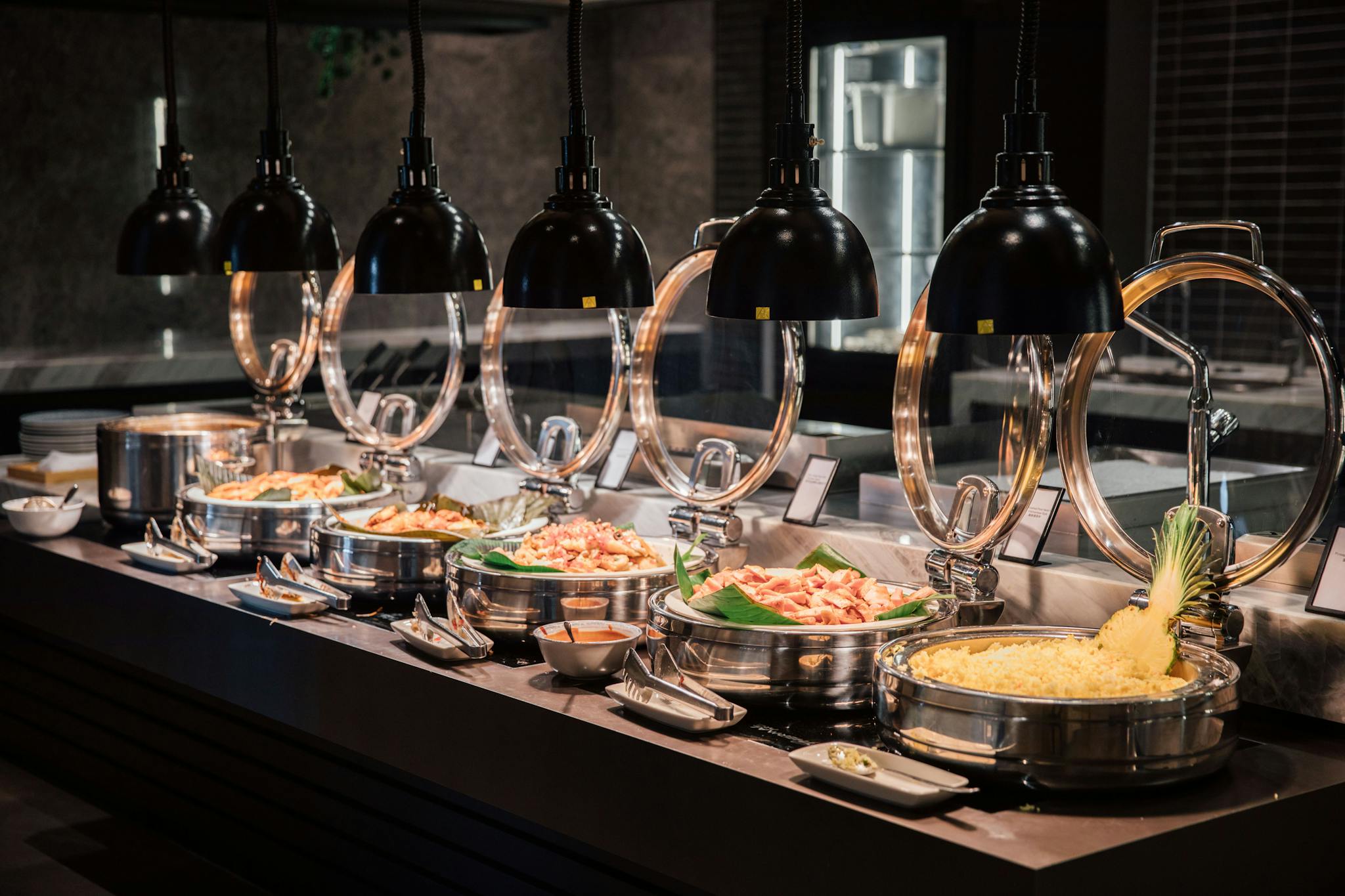 A beautifully arranged buffet with various dishes under warm lighting, perfect for events or hospitality photography.