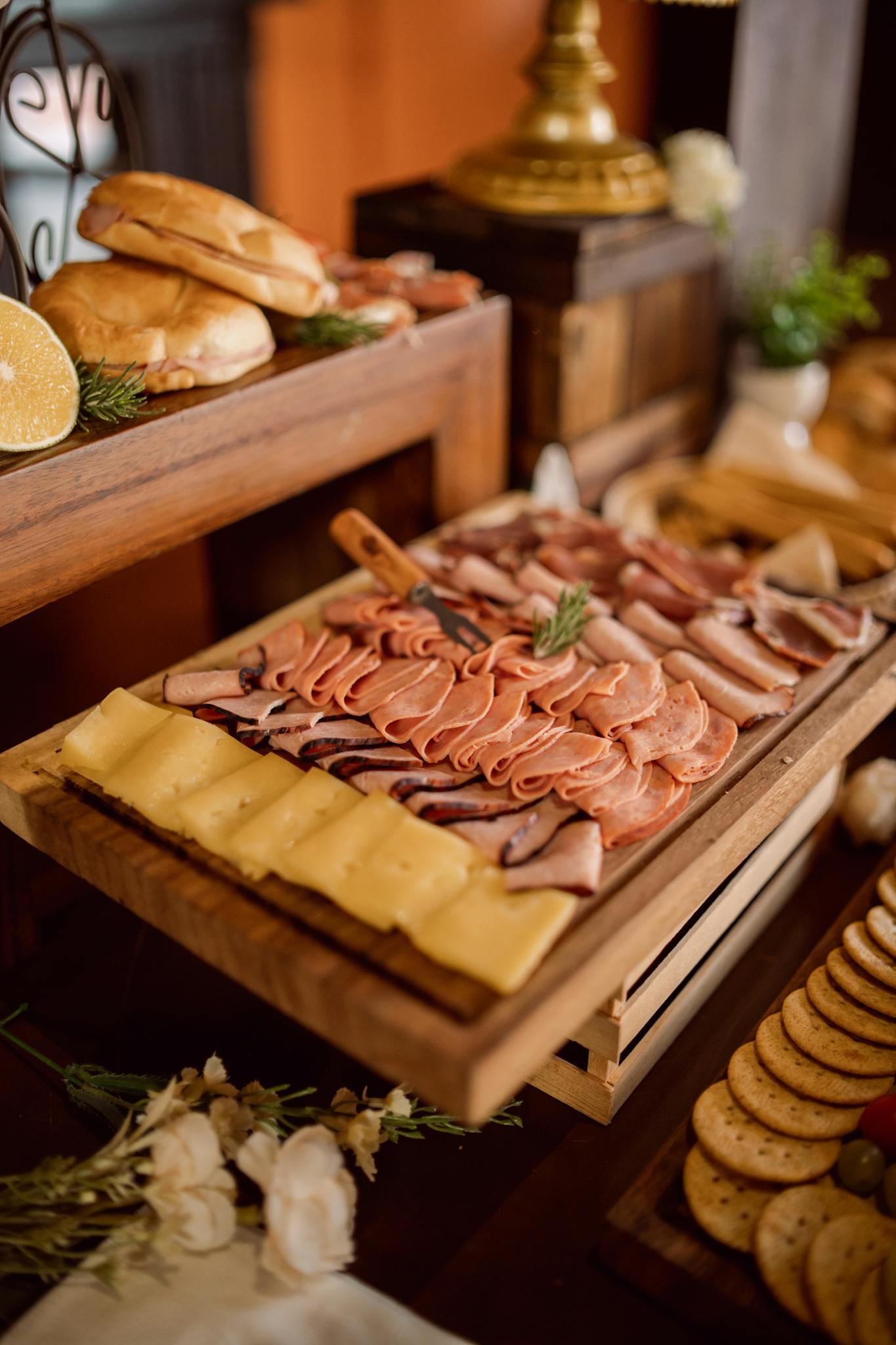 A beautifully arranged charcuterie board featuring cold meats, cheeses, and bread, ideal for weddings or events.