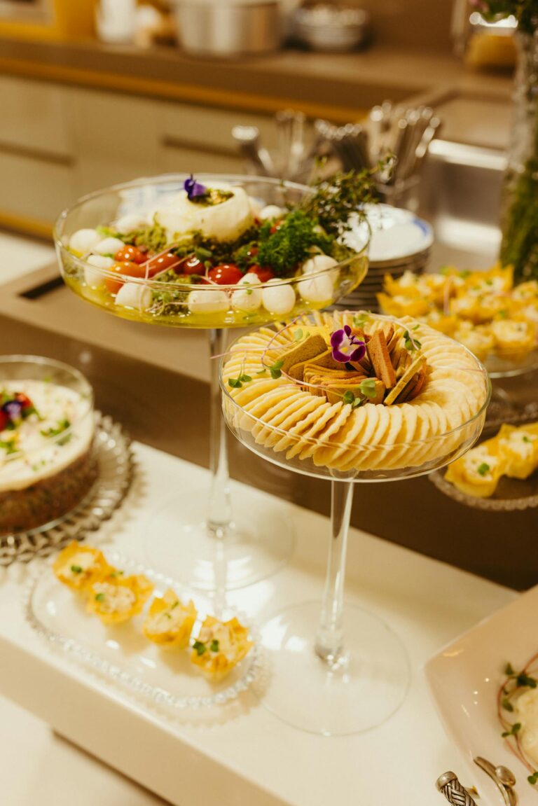 Exquisite display of appetizers featuring gourmet cheese, crackers, and fresh salad at a buffet.
